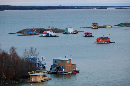 The iconic view of Yellowknife Bay (AKA 'Houseboat Bay') from the top of Pilot's Monument in Yellowknife's Old Town. These houseboaters are living off the grid in their floating homes in Great Slave Lake.