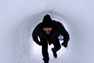 Bryan going through the tunnel under the ice slides at the Snowking Castle